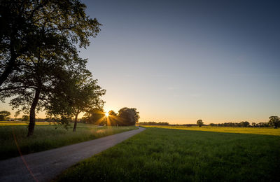 Scenic view of field against sky during sunset