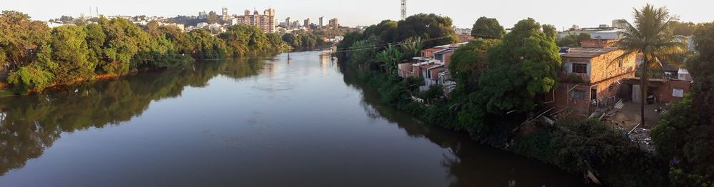 Scenic view of lake by buildings against sky