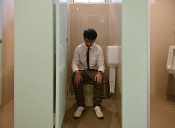 Full length of man in toilet