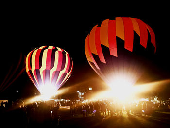 Illuminated hot air balloon against sky at night