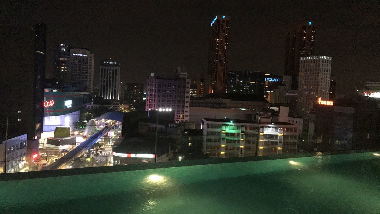 ILLUMINATED CITYSCAPE AGAINST SKY AT NIGHT