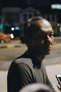 Portrait of man using smart phone on street