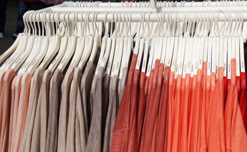 Close-up of sweaters hanging on rack for sale