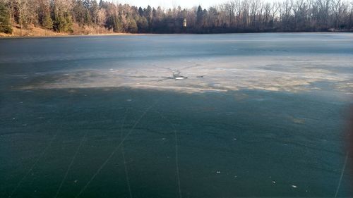 Scenic view of lake against sky during winter