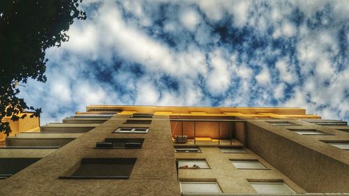 Low angle view of building against cloudy sky