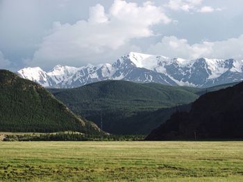 Scenic view of mountains against cloudy sky