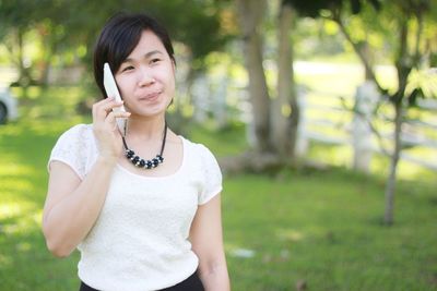 Portrait of smiling young woman standing outdoors