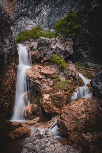 Waterfall in the mountains in spring with refreshing splashes