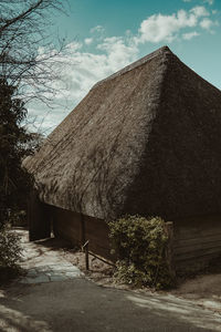 House amidst trees and buildings against sky