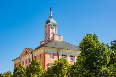 Low angle view of building against sky during sunny day