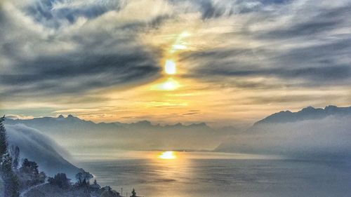 Scenic view of sea and mountains during sunset