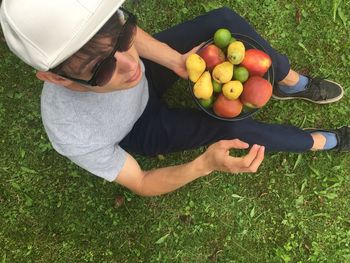 High angle view of man holding a bowl of fruits