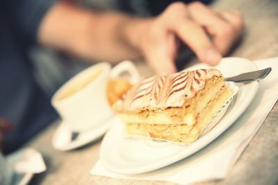 Close-up of hand holding cake
