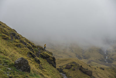 Scenic view of mountains against foggy sky