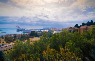 High angle view of buildings against cloudy sky