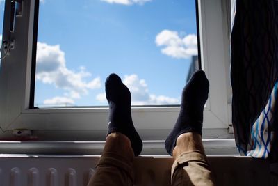 Low section of woman relaxing in the dark