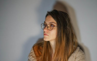 Close-up portrait of young woman at home