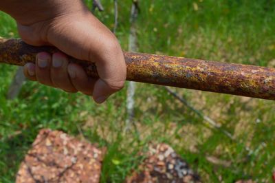 Close-up of hands on grass