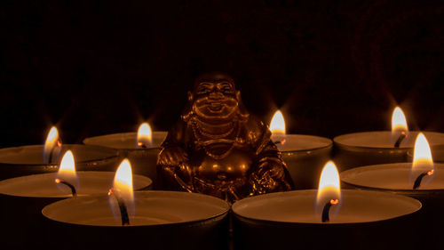 Close-up of illuminated tea light candles