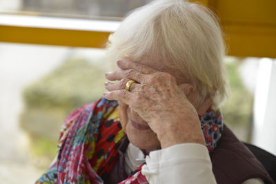 Close-up of woman with head in hand