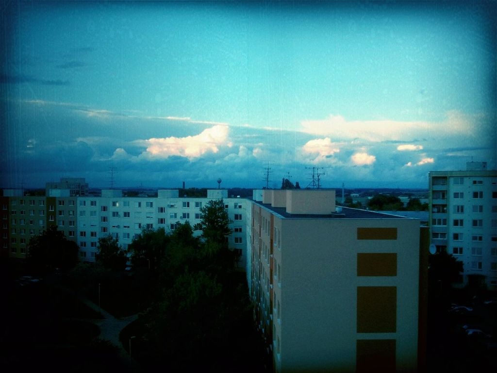 building exterior, architecture, built structure, sky, city, residential structure, residential building, house, cloud - sky, auto post production filter, blue, residential district, transfer print, cityscape, dusk, cloud, building, no people, outdoors, tree