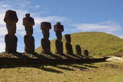 Stack of stones on land against sky