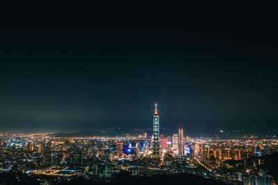 High angle view of illuminated buildings against sky at night