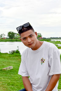 Portrait of young man standing on field