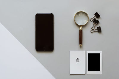 High angle view of smart phone and book on table