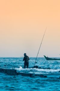 Man on sea against clear sky