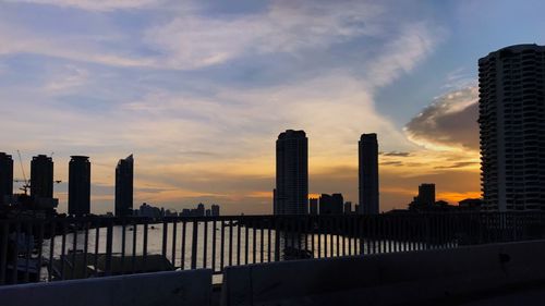 View of cityscape against cloudy sky