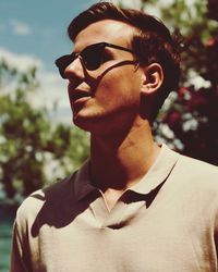 Close-up of young man wearing sunglasses during sunny day