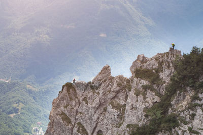 Low angle view of people on mountain against sky