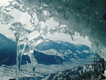 Close-up of ice on mountain against sky