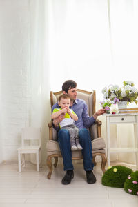 Friends sitting on floor at home