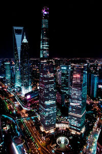 High angle view of city lit up at night
