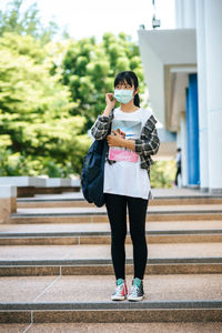 Full length of woman holding umbrella