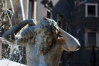 Fountain splashing on statue