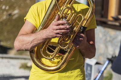 Midsection of man playing guitar