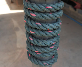 Close-up of rope tied on wooden post