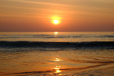Scenic view of sea against romantic sky at sunset