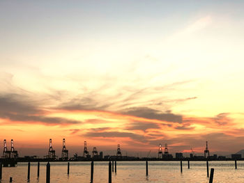 Silhouette of pier on sea during sunset