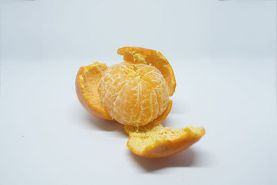 Close-up of orange fruit on white background