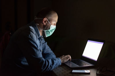 Young man using laptop at home