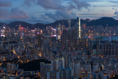 Illuminated cityscape against sky at night