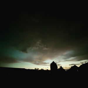 Low angle view of silhouette landscape against sunset sky