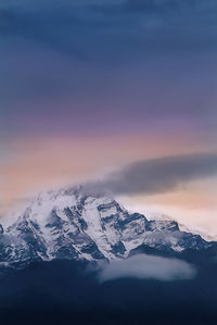 Scenic view of snowcapped mountains against sky during sunset