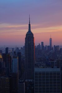 View of buildings in city at sunset