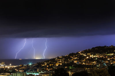 Lightning over city against sky at night