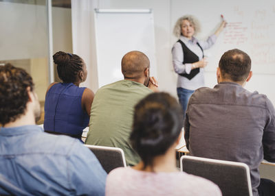 Teacher explaining to multi-ethnic students at language class